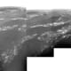 Surface of Titan: multiple photos snapped by Huygens from about 5 miles above the ground. A few white wisps of fog (?) hug an alien landscape scoured by wind and methane rains.