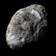 The moon Hyperion. Smaller bodies (it's 255 x 163 miles) don't have enough gravity to pull them into a spheroid shape; they tumble like space potatoes. Hyperion seems to be a loosely-packed sponge or honeycomb of dirty ice.