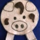 Cut out another face for the other side of the pig, and cut mud splotches from brown felt. Flip over to this side when you get to the part in the rhyme when they jump in the mud.