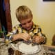 Tie a string hanger onto the pine cone first.