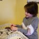 Tie a string hanger onto the pine cone.