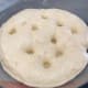 Poke the dough to let the air out.