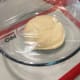 Transfer the dough into a large greased bowl. Cover with cling wrap.