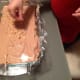 My daughter is sprinkling the top layer with hazelnuts and chocolate shavings.
