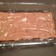 The layer of chocolate cream is spread thinly over the biscuits.
