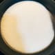 Pour one cup of white granulated sugar into a prepared pan. Heat up the sugar on low heat.