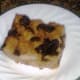 A slice of bread pudding ready to be garnished or eaten as is.