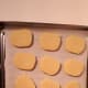 Leave a finger width space between each cookie on the tray.
