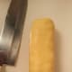 Slice the cookie dough with a fairly sharp knife like a paring knife or a chefs knife. Kitchen cutlery knives will do in a pinch but they tend to mash the dough more.