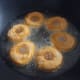 Fry the donuts in a pan or a wok.