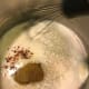 Add red pepper flakes, black pepper and cumin to the hot oil and flour mixture, and whisk to combine. This helps release more of the flavor of the pepper and cumin.