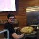 George unloading the freshly-baked pizza from the oven..