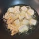 Place coated chicken pieces into the pan gently, using tongs, to avoid splashing oil.