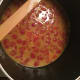 Right after adding the drained canned diced tomatoes. The curry and cayenne pepper really changed the color of the stock.