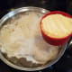 Now very slowly add your cornmeal and whisk thoroughly to make it smooth.