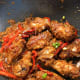 Coat the chicken with the sauce. Sprinkle the sliced spring onions on top.