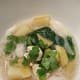 In a serving bowl, assemble the rice noodles and mustard green. Pour the broth on top. I like a lot of broth over the noodles.