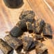 Cut the palm sugar into small chunks before putting them in a pan.