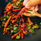 Throw in the dried red chilies.