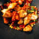 Throw in the fried chicken into the sauce and vegetable mixture.