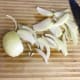 Slice the onions about a quarter inch thick. Any thinner and the juices will cook out too quickly, causing the onions to burn. Any thicker and they won't caramelize properly. When cutting the onions, go against the grain just like in the photo.