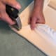 Step 4- It's important to pull the flannel tight as you go along with the staple gun, this way your fabric will be nice and smooth on the other side of the board and your felt pieces will stick without effort.