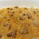 Layering of soup mixture, chopped onions, chopped cooked meat (in this case, chicken fajitas), and cheese over tortillas