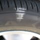 The outer front tire has more weight on it as the car leans and, therefore, uses the entire tread width, even when overinflated by 5 psi.