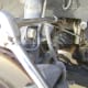 L. Loosen and remove the power steering pump adjustment bolt, with a socket wrench attached to a ½” extension.