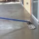 As the concrete was poured into each section of the patio, a worker with a long, very long, pole smoothed the surface.