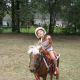 My granddaughter with her pony and riding helmet.