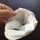 Step 4. Roll the top of the toilet paper down gentle to create a "lip."