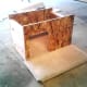 House framework set on the carpeted base.
