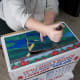 Cutting a hole through both the lid and bottom of the box to make windows or doors.