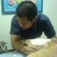 One of Peso's veterinarian, trying to find his bladder through his stomach