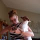 Hold the dog under your arm, so they feel slightly insecure. This will cause them to allow you to clip their nails very quickly without nipping.