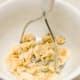 Mash the bananas with a potato masher.