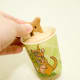 Gently squeeze the sides of the cup to release the pupsicle. You may have to also slightly push on the bottom. Once it's released, pull it out by the biscuit handle. If you pull on the biscuit before it's released from the cup, the biscuit may break.
