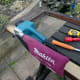 Using a belt sander to take the surface back to the bare wood.