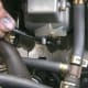 Location of one vacuum fitting. The hose has been removed and the socket extension is nearly touching the #3 vacuum port and the #4 port is also visible to the right of that one.