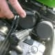 Location of one of the upper adjustment screws: the screwdrive is ready to turn the screw.