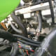 The bolt has been removed, leaving a threaded hole where a fitting must be installed for the tool.