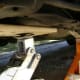 Support the engine with a jack. Use a wood plank to prevent damage to the oil pan.