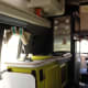 A kitchen with sink, stove, microwave, and fridge glammed with chartreuse and silver.