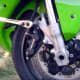 Loosening the first of the two bolts holding the caliper to the bike.