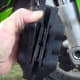 Caliper has been removed - the old brake pads are clearly visible.