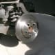 Bracket has been removed and the rotor replaced with a new one. It slides over the same bolts that hold the wheel on.