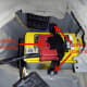 Location of the positive battery terminal (remove the entire plastic assembly in one piece) and the battery hold down bolts.