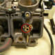 Remove the needle jet holder and slow jet (circled in red). Do NOT remove or adjust the set screw (circled in black).