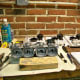 Picture of carburetors completely disassembled and ready to be cleaned. Note that all of the parts in background neatly organized on notebook paper.